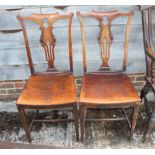 A pair of mid Georgian provincial fruitwood hall chairs with pierced splat backs and panel seats, on