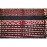 An Ikat panel of multi stripe design in shades of red, blue, natural and yellow, from Savu,