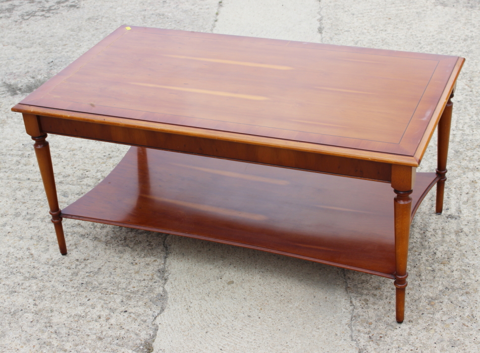 A yew wood and banded coffee table, 40" long, and a nest of three similar occasional tables, 23"
