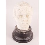 A white marble bust of a young man, on ebonised base, 7 3/4" high (damages)