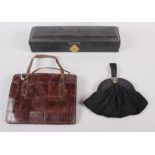 A morocco leather scroll box with silk lining, a crocodile skin handbag and a black evening purse