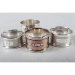 A presentation silver napkin ring, 1.3oz troy approx, two engine turned silver napkin rings, 0.7oz
