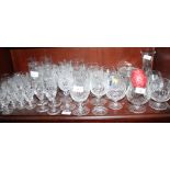 A quantity of cut glass drinking glasses, including brandy balloons, wines, champagne flutes,
