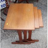 A nest of three teak tables, 22" wide