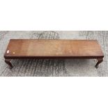 An oak low footstool, on cabriole supports, 48" wide