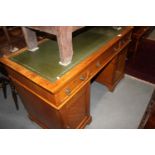 A late 19th century light oak double pedestal desk in the Aesthetic style, fitted three drawers over