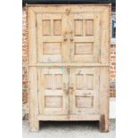 A Continental pine cupboard enclosed four panel doors, on stile supports, 51 1/2" wide x 23" deep