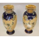A pair of Royal Doulton tube-lined ware vases with floral decoration, 12" high