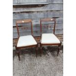 A set of six early 19th century carved rosewood bar back dining chairs with drop-in seats, on reeded