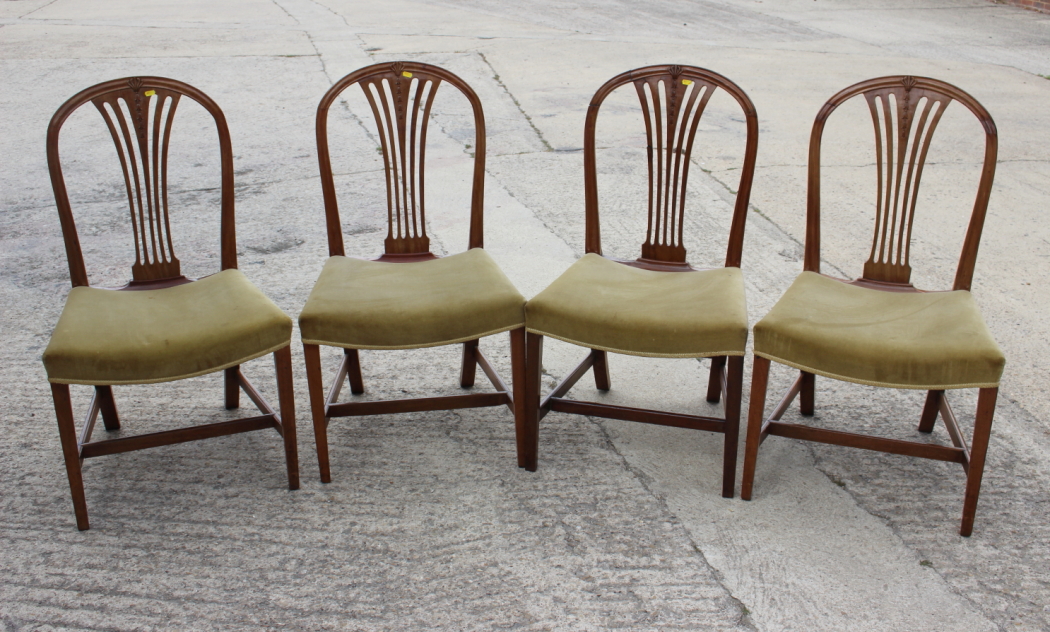 Four George III design standard dining chairs with stuffed over seats, on square taper stretchered