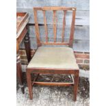 A pair of Sheraton Revival vertical rail back dining chairs with stuffed over seats, on square taper