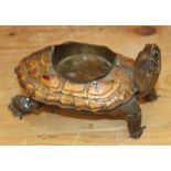 A taxidermy tortoise, now converted to an ashtray, 7" long (damages)