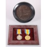 A WWI British Service and Defence medal, in frame, and a death plaque