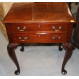 A reproduction mahogany lowboy of Georgian design, fitted two drawers, on cabriole supports, 24"