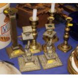 Three pairs of brass candlesticks, including a pair formed as dolphins, and a single column-shaped