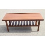 A teak two-tier coffee table, 48" wide