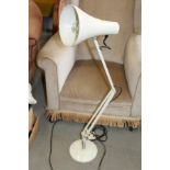 A white Anglepoise lamp, on circular base