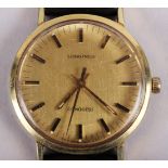 A gentleman's Longines Conquest wristwatch with gold dial and baton numerals, on brown leather strap