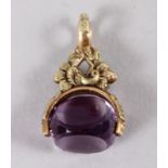 A 19th century yellow metal and amethyst fob spinner with floral decoration