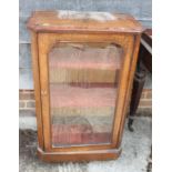 A Victorian walnut and banded pier/music cabinet enclosed glazed door, on castored supports, 22"