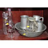 A pewter bowl, seven antique pewter plates, three pewter tankards, two glass decanters and a