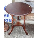 An oak circular two-tier occasional table, on tripod supports, 21" dia