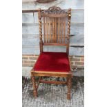 A Victorian mahogany loop back side chair with leather stuffed over seat, on turned supports, and