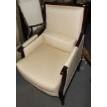 A French Regency design mahogany showframe armchair, upholstered in a cream brocade, on reeded