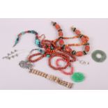 A collection of coral bead necklaces, a carved jade pendant and other jewellery