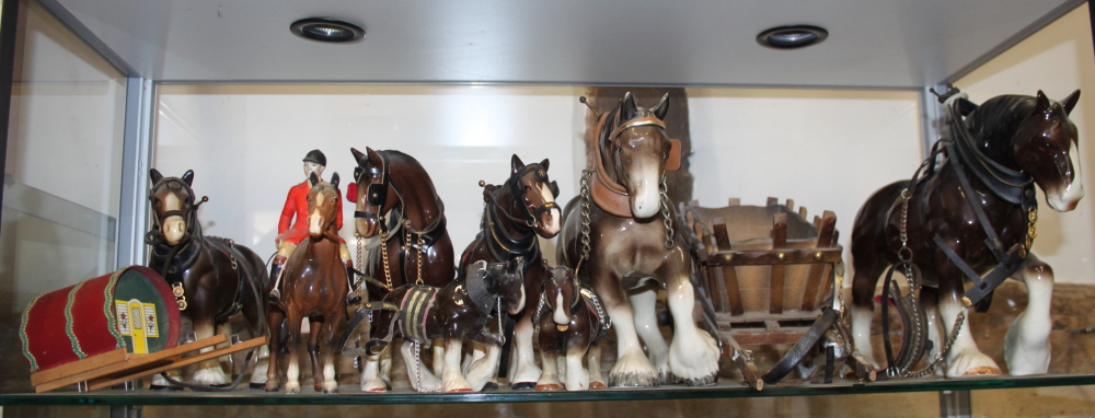 A Beswick model of a horse with jockey and other model horses and carriages