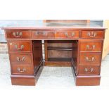 A mahogany double pedestal desk with green tooled leather top, fitted nine drawers, on block base,