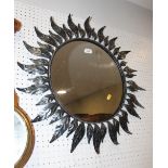 A black metal leaf decorated circular mirror, 15" dia
