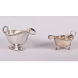 A silver pedestal sauce boat with gadrooned border and a smaller silver sauce boat, 12.3oz troy