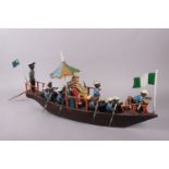 A vintage wooden model boat with figures