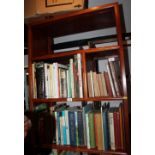 A Chinese hardwood wall unit, fitted open shelves over two short and three long drawers, on block