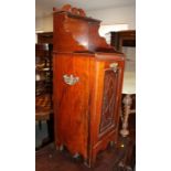 A walnut coal purdonium with raised back, carved central panel and carrying handles, on stile