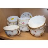 A quantity of early 20th century Meissen teacups, saucers and a sugar bowl (one cracked)
