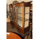 A late 19th century walnut double bowfront display cabinet enclosed leaded glazed doors, on cabriole
