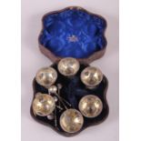 A set of six Victorian silver salts and spoons with embossed decoration, in fitted case, 7.1oz