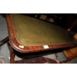 A mahogany low coffee table with green tooled lined top on splay supports, 36" x 15 1/2" x 17" high,