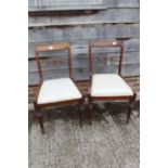 A set of six early 19th century carved rosewood bar back dining chairs with drop-in seats, on reeded