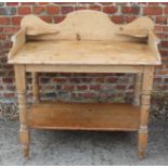 A waxed pine two-tier washstand with tray top, on turned supports, 36" wide x 20" deep