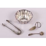 A silver sugar bowl, a silver mustard spoon, a pair of silver tongs and a white metal leaf-shaped