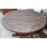 A wooden circular slatted garden table, 41" dia