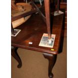 A walnut extending dining table with extra leaf, on cabriole supports and pad feet, 60" x 30" when
