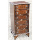 A walnut and banded bedside chest of six long drawers, on bracket feet, 15 1/2" wide x 15" deep x