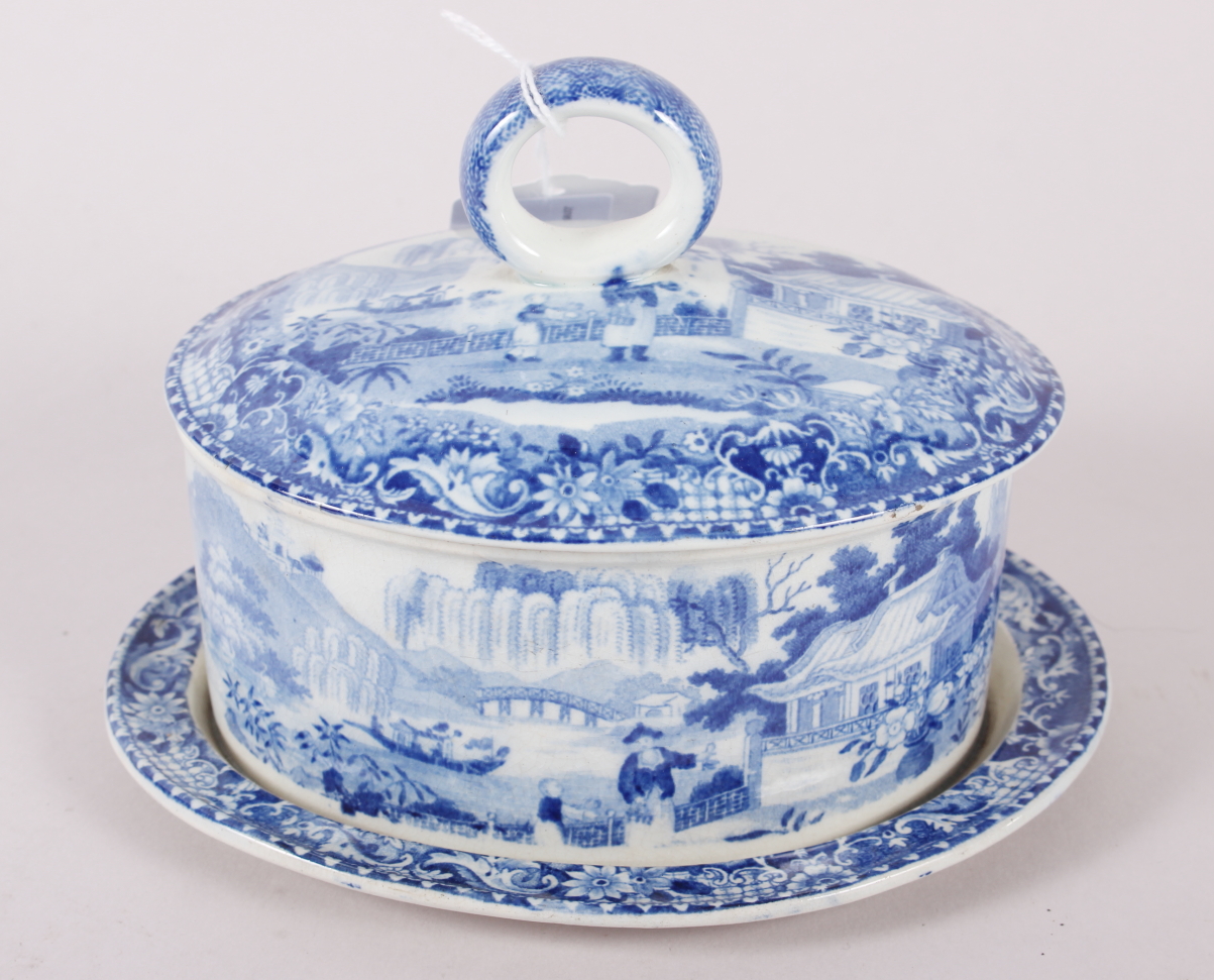An early 19th century Davenport "Chinese Garden" pattern oval butter dish and cover with integral