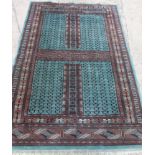 A Bokhara hatchli rug of traditional design, on a blue ground, 78" x 50" approx
