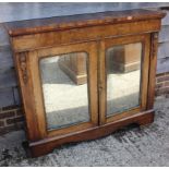 A late Victorian walnut and banded credenza/pier cabinet enclosed two arch top mirror panelled
