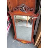 A mahogany framed wall mirror with ho ho bird pediment